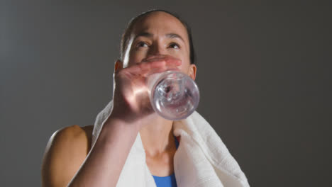 Close-Up-Shot-of-Young-Woman-Drinking-From-Bottle